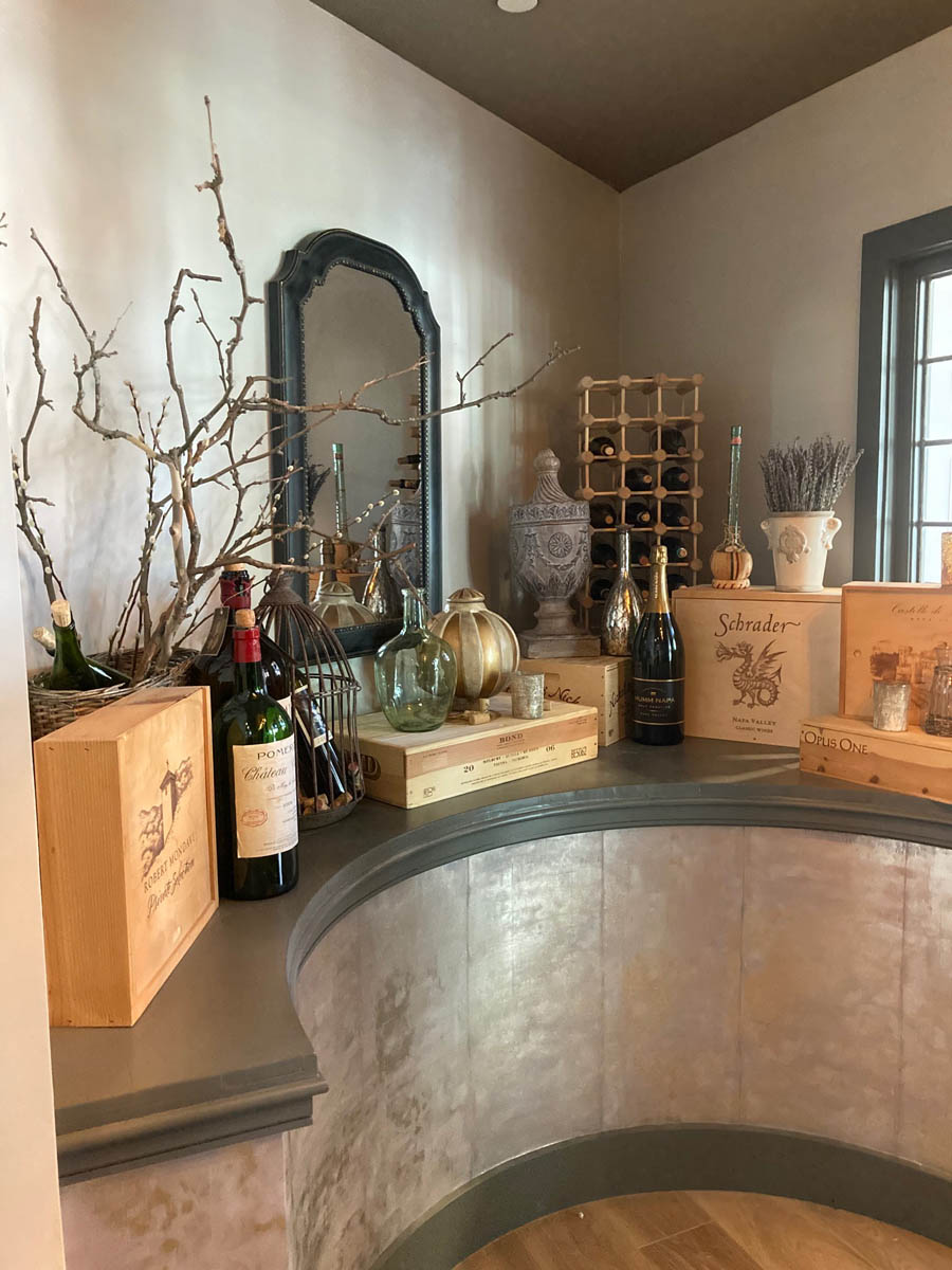 Table decor - large format wine bottles, wines in rack, boxes and cases inside the main entrance at Napa Kitchen + Bar in downtown Toledo, Ohio.