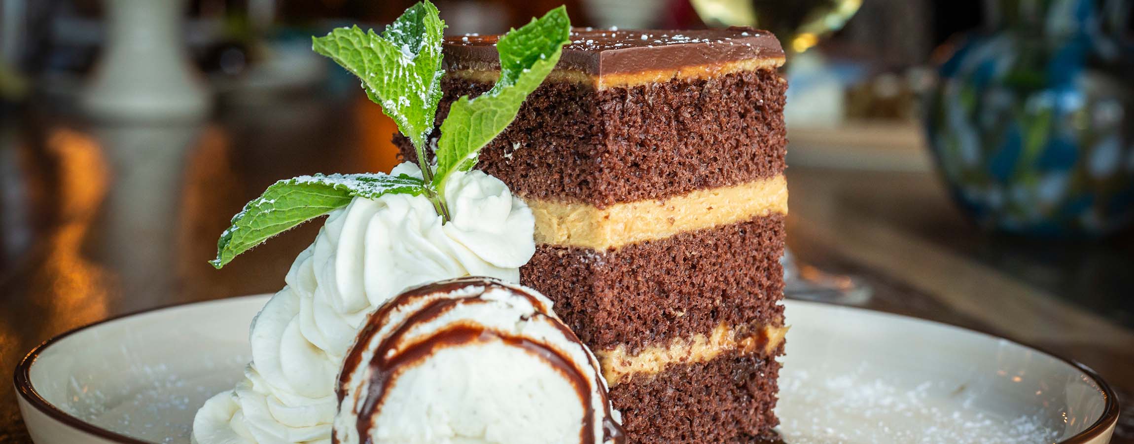 Peanut Butter Chocolate Cake with whipped cream served at Napa Kitchen & Bar.